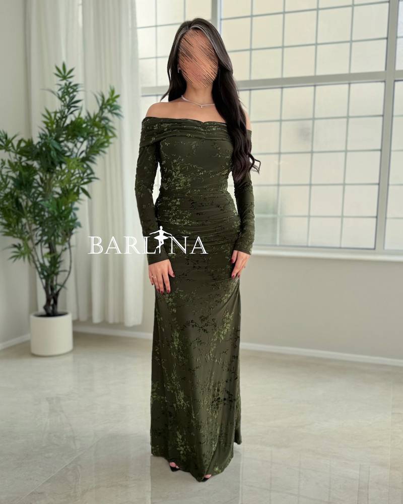 A green dress with a subtle pattern and a hint of shine.