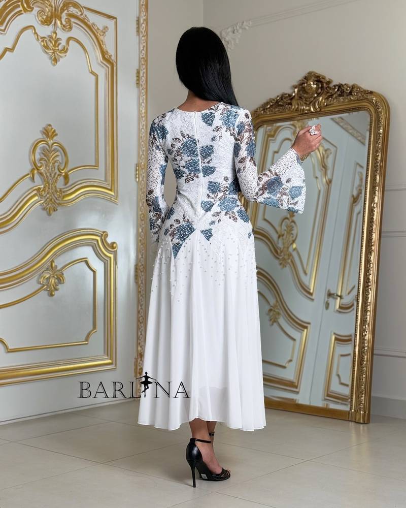 A soft white dress with blue floral embroidery