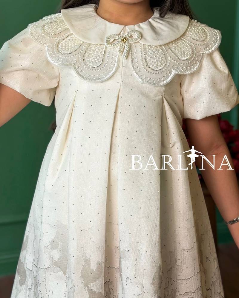 A short girl's dress decorated with delicate embroidery