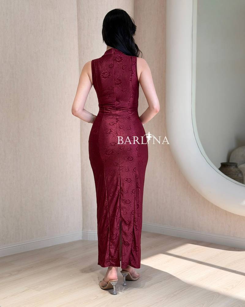 A simple, fitted burgundy dress with a subtle pattern