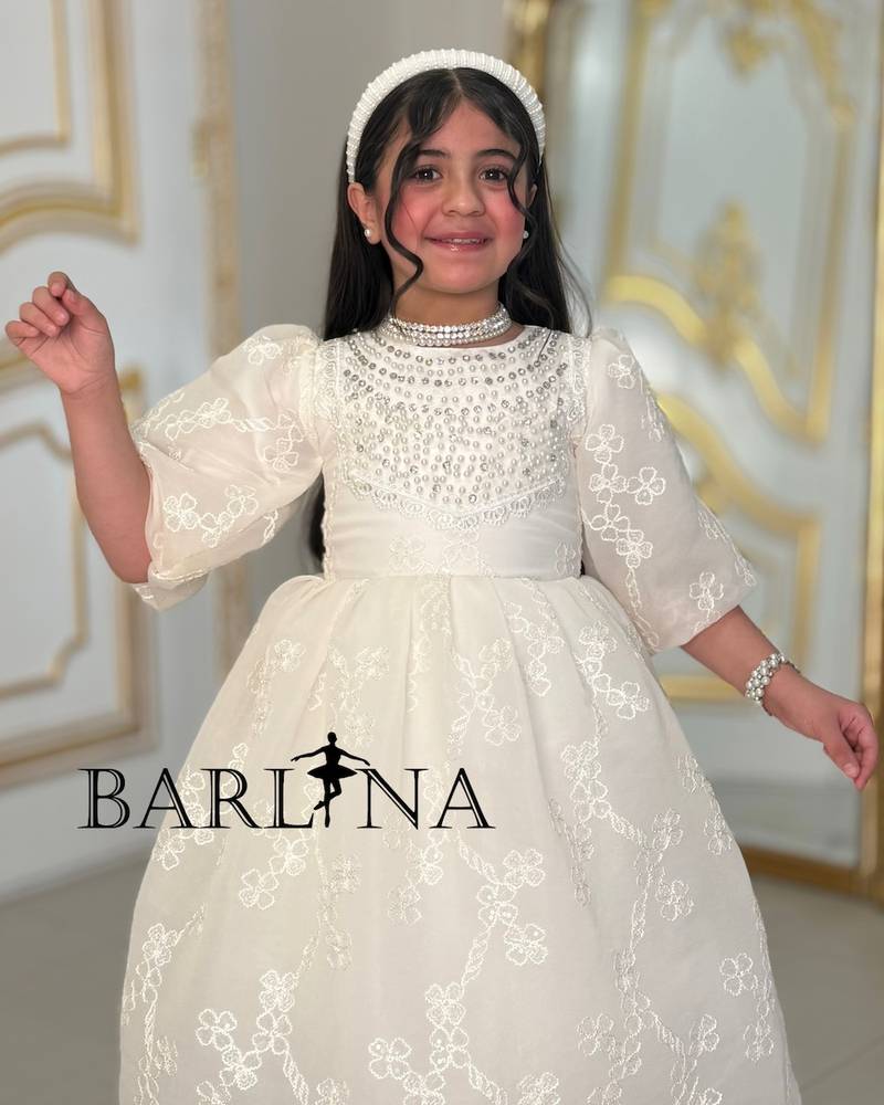 A soft, pearl-decorated girl's dress