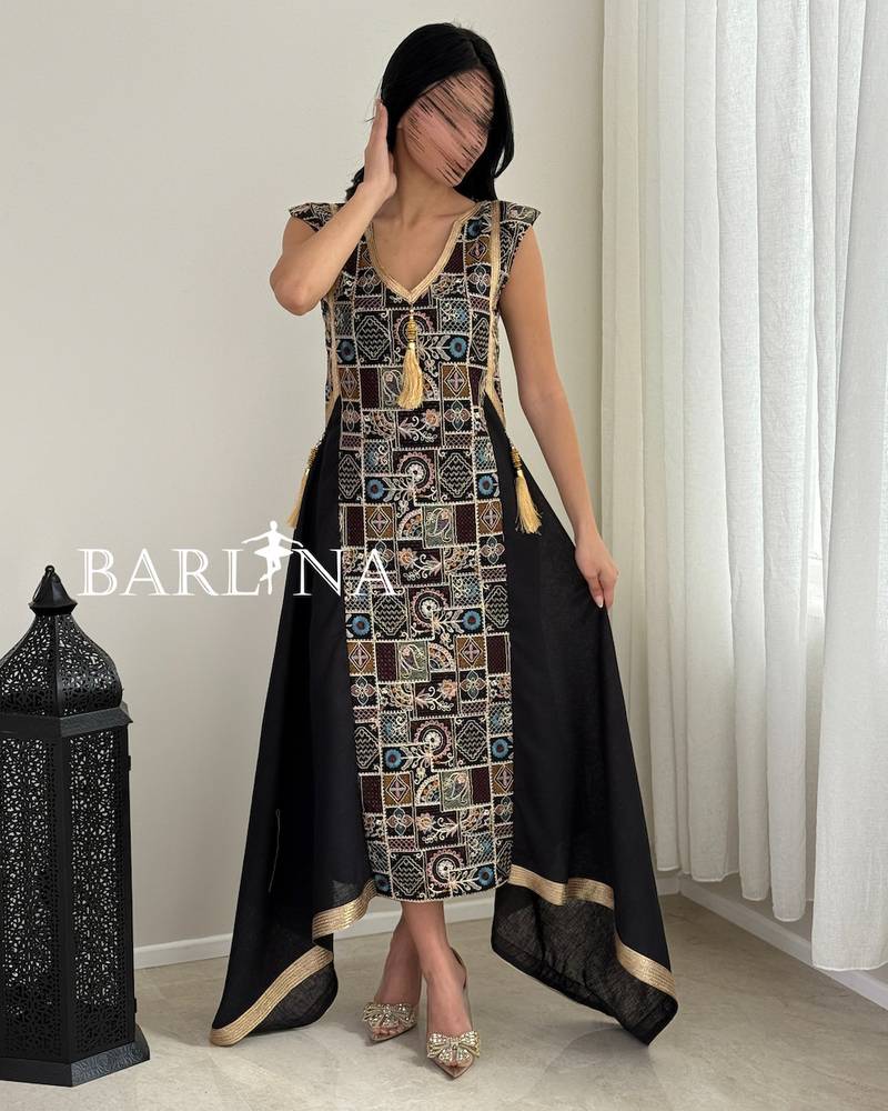Black jalabiya with traditional embroidery and gold accents