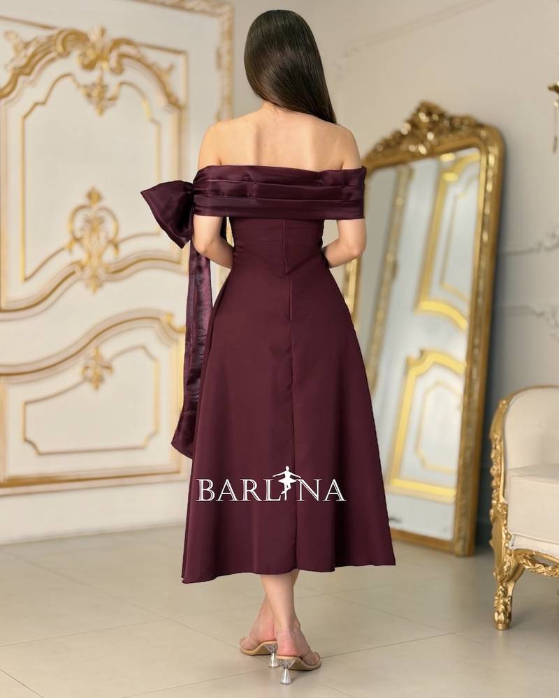 A burgundy off-the-shoulder dress with an elegant design