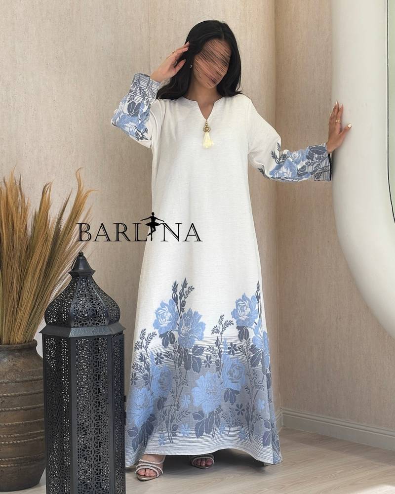 White jalabiya with a blue floral pattern
