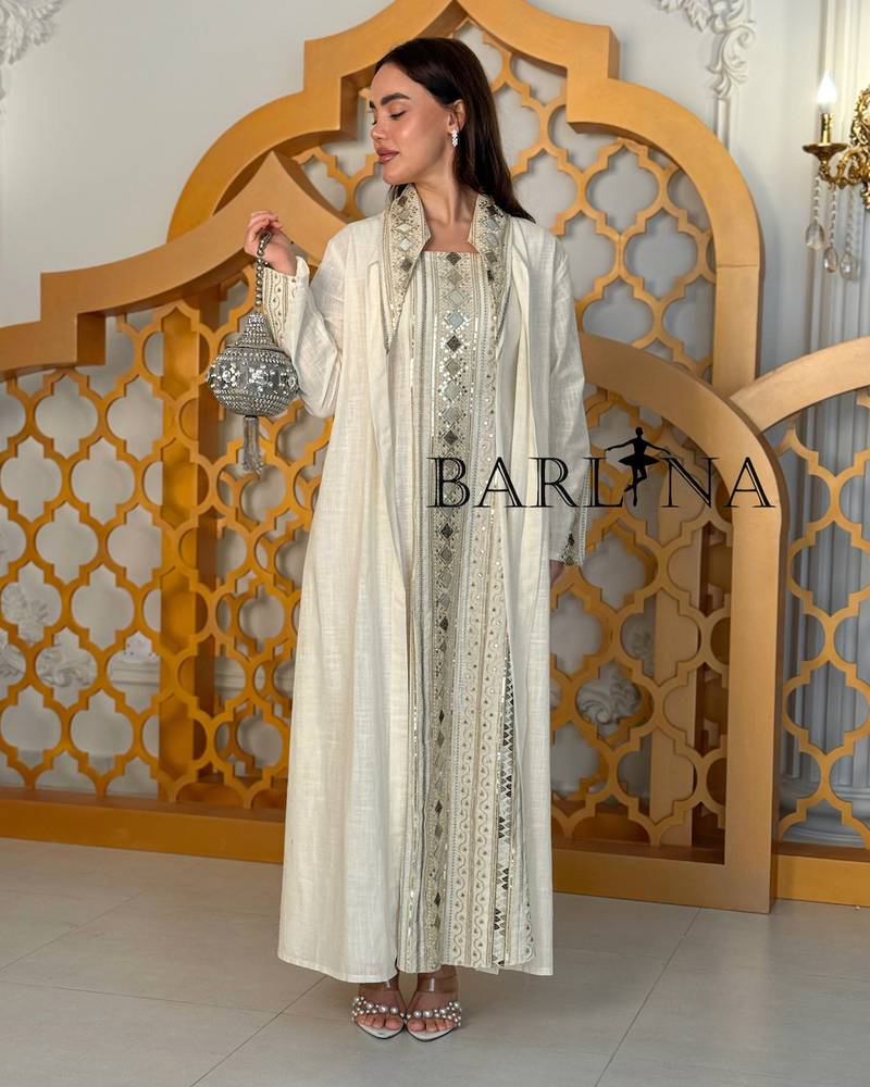 A cream-colored jalabiya with embroidery details and an oriental touch.