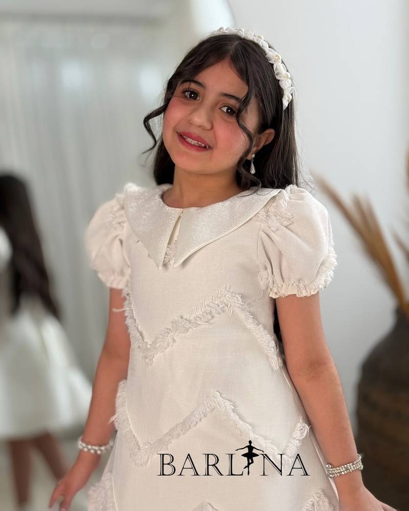 Off-white girls' dress with embroidered fabric
