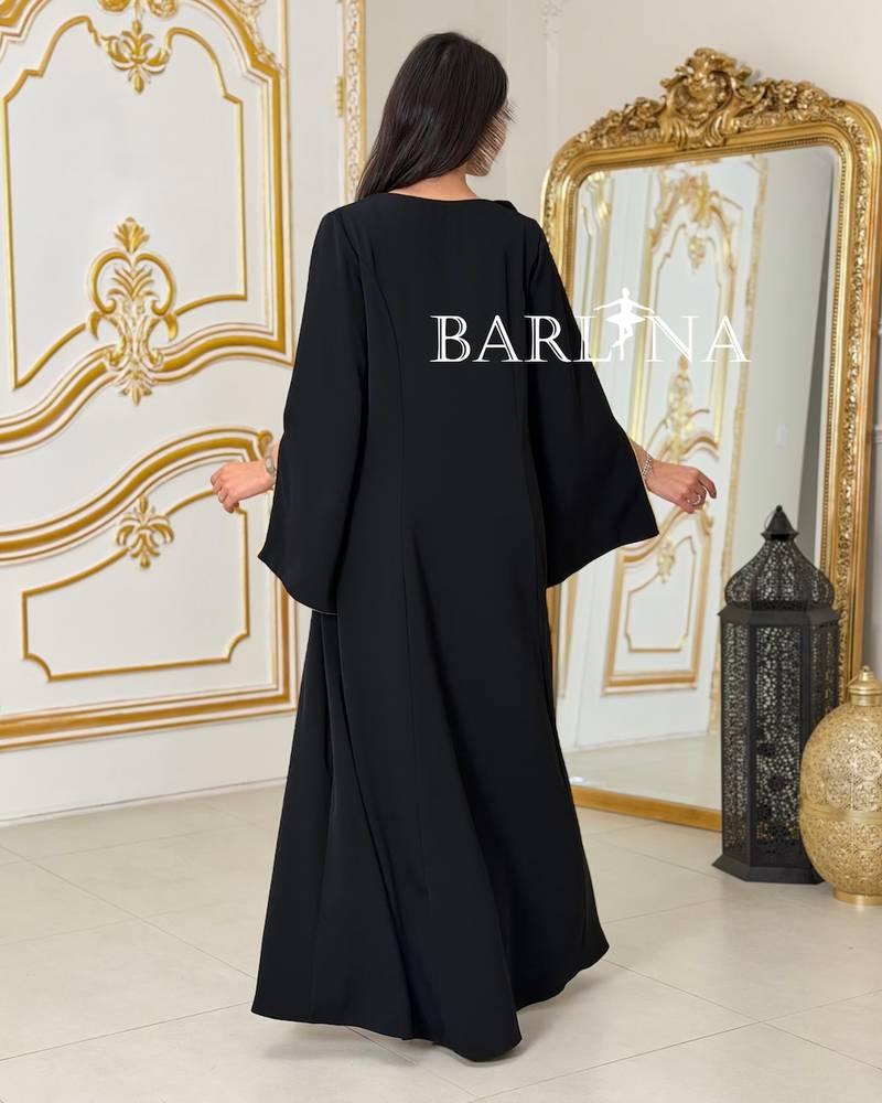 Black jalabiya with green sleeves decorated with roses