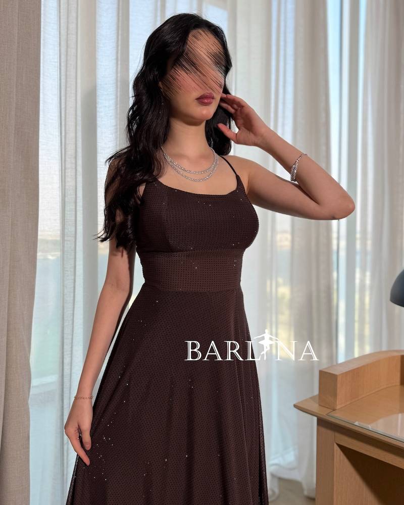 A dark brown sparkly dress with thin straps