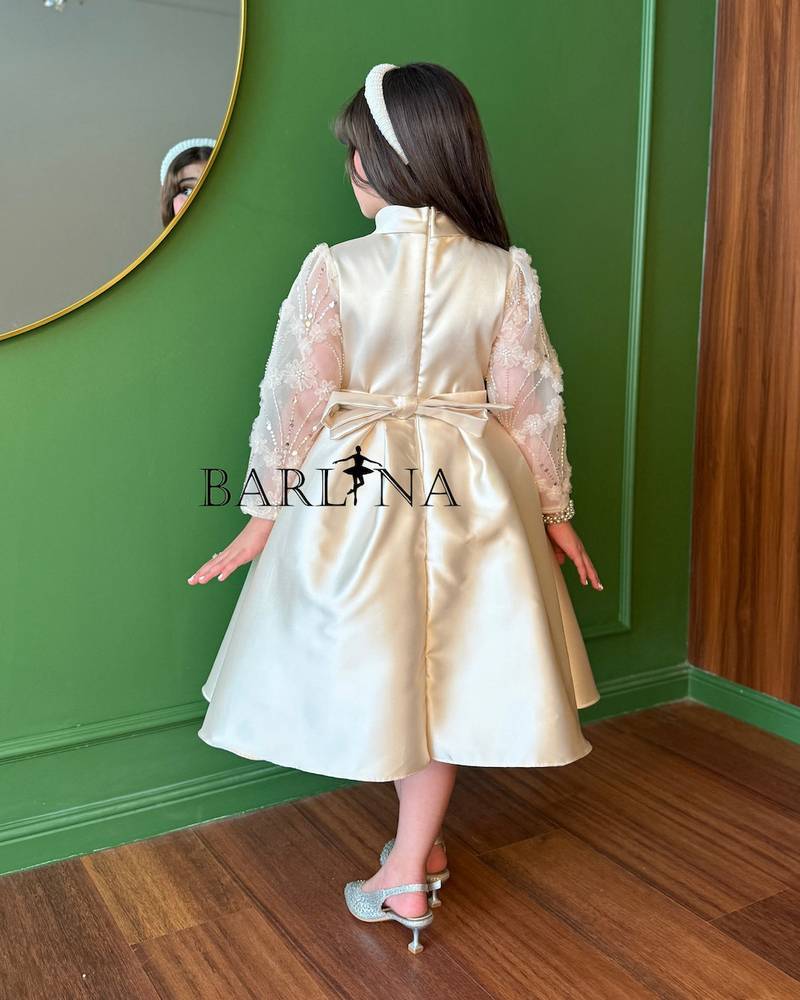 Beige girls' dress with sheer embroidered sleeves