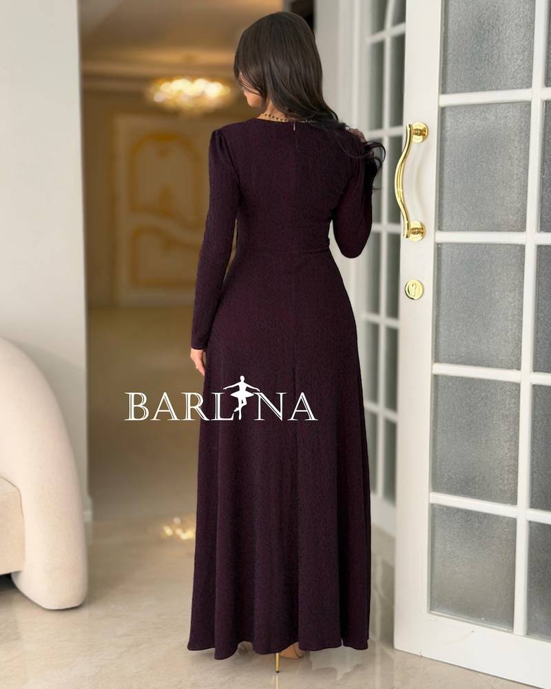 A long burgundy dress with a decorative beaded detail