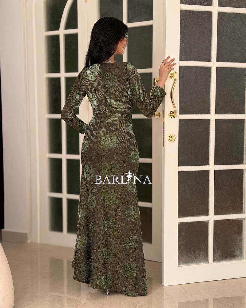 An olive-green evening dress embroidered with elegant designs.