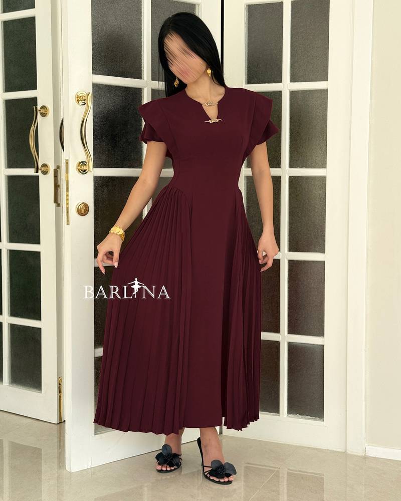 A soft burgundy dress with side pleat details
