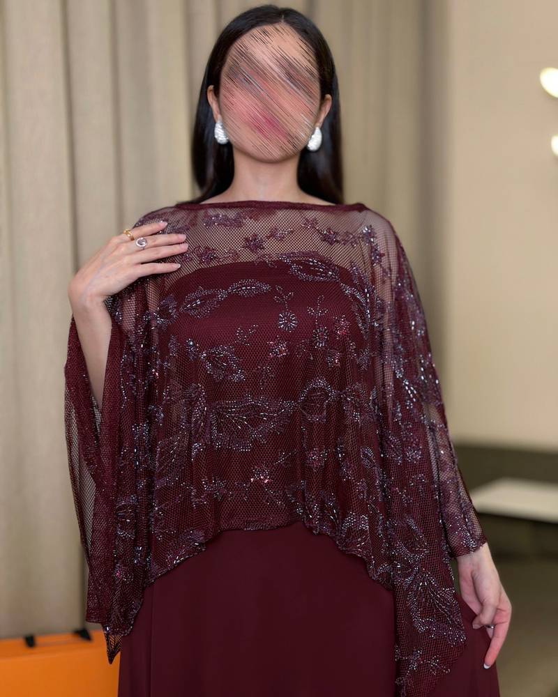 Elegant burgundy dress with a sheer embroidered panel.