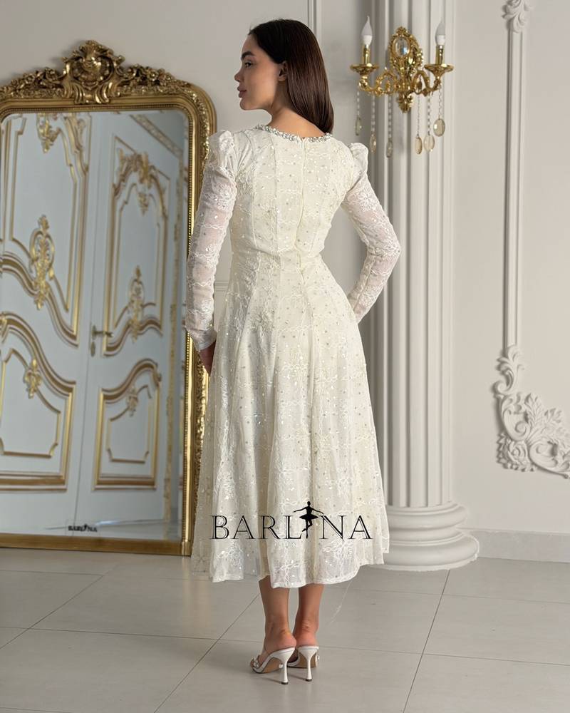 Elegant off-white dress with embroidery at the neckline