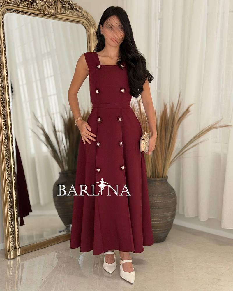 Elegant burgundy dress adorned with striking details