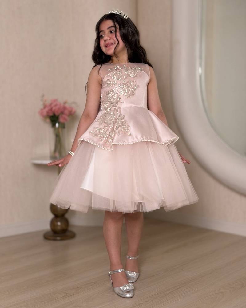 Pink girl's dress decorated with sparkly embroidery