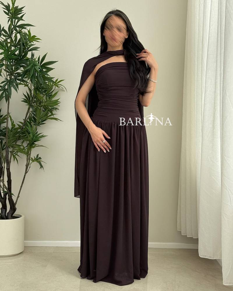 A flowing brown dress with a shawl around the neck