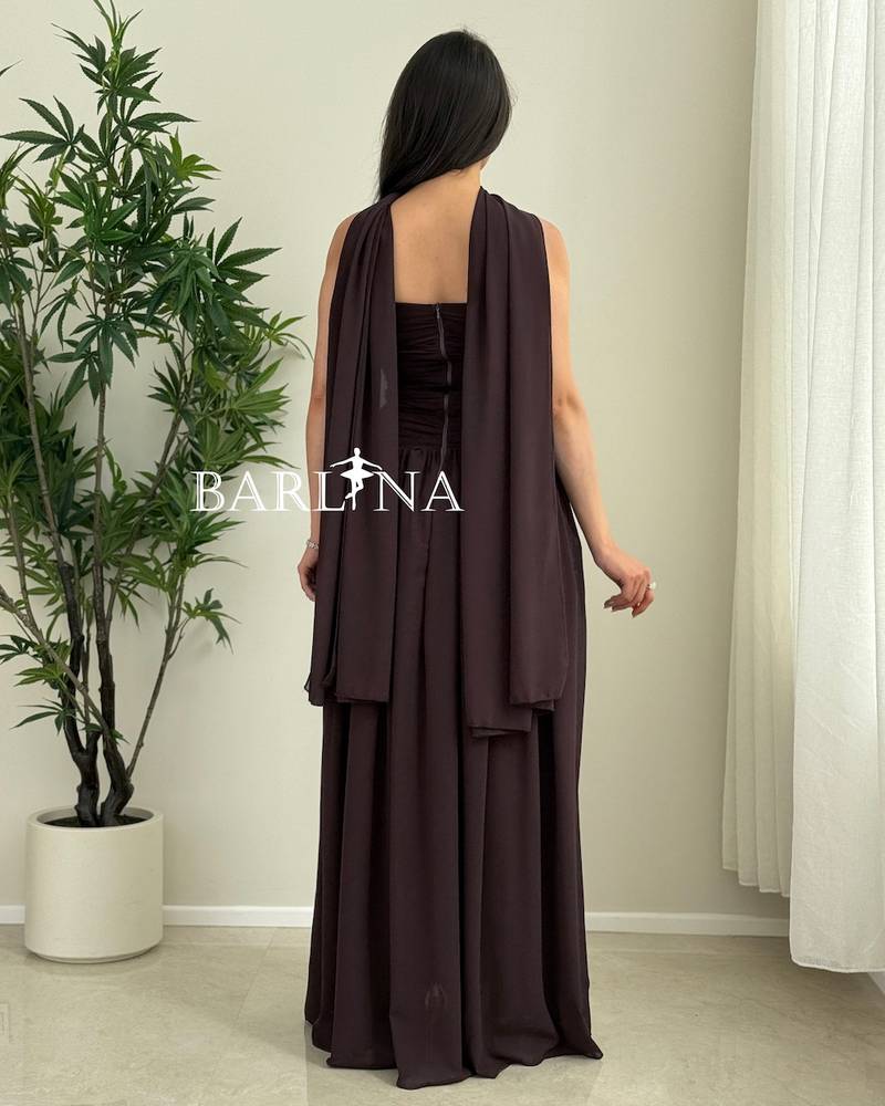 A flowing brown dress with a shawl around the neck