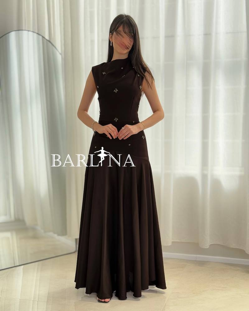 Black dress with crystal embellishments and a draped collar