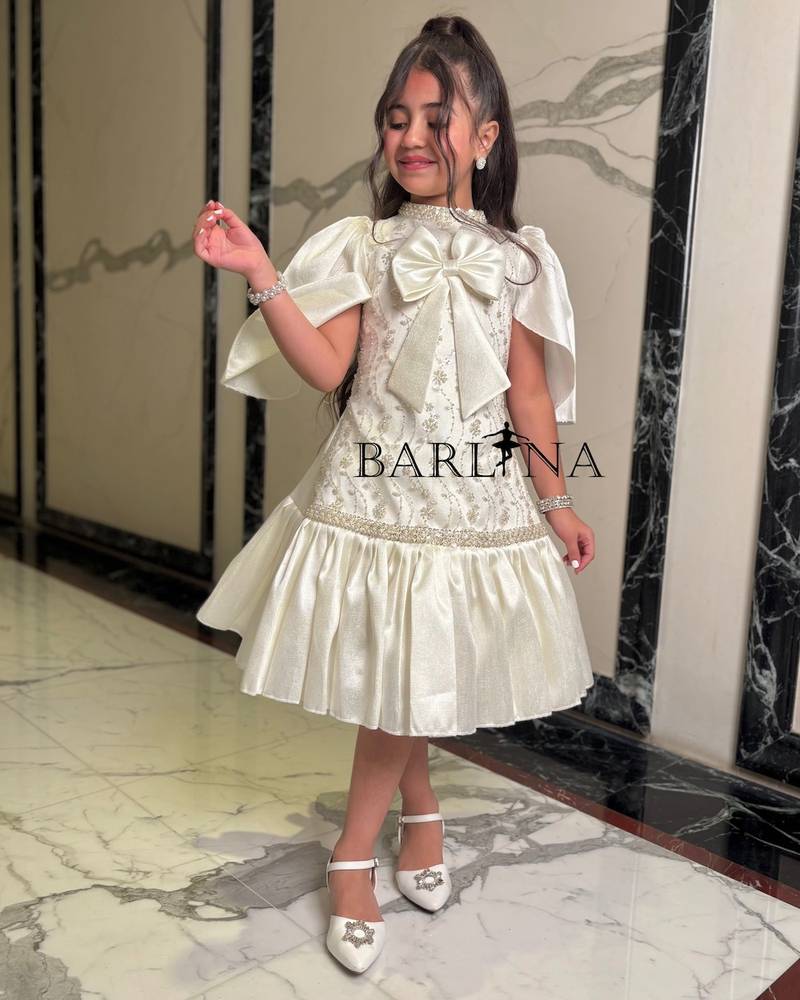 Ivory girls' dress with cape-style sleeves