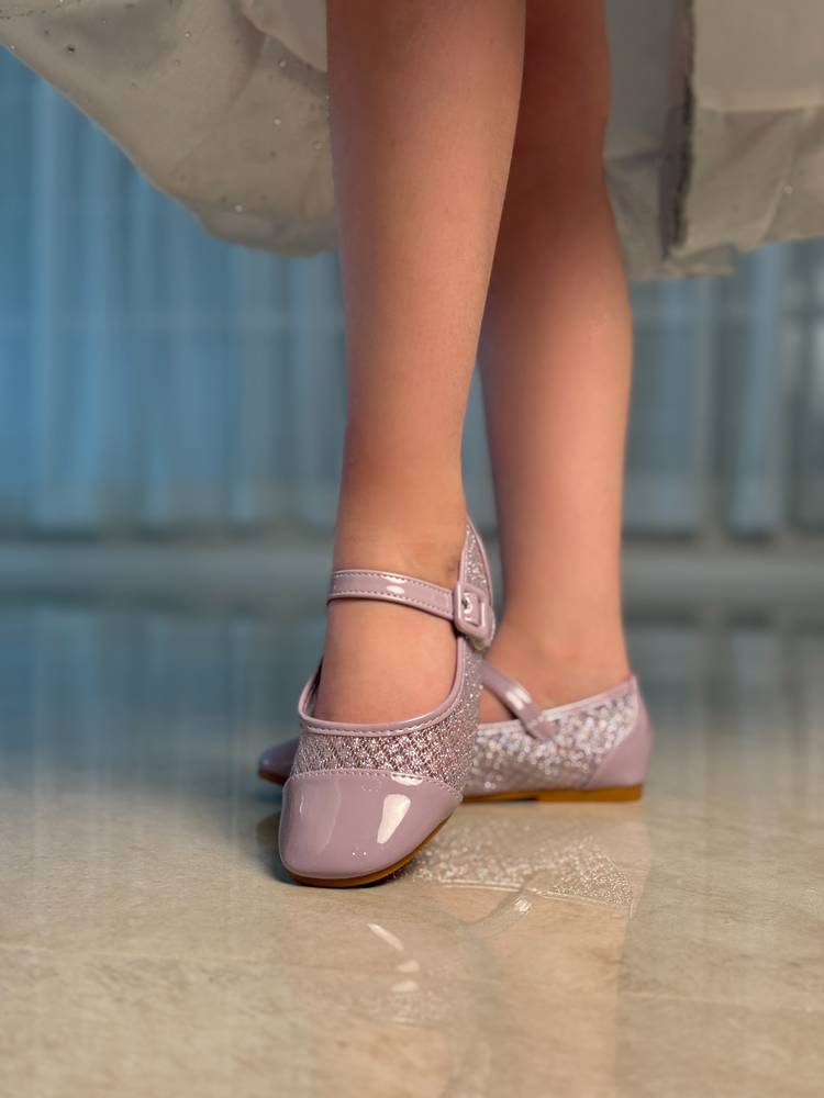 Girls' shoes with a shiny material and leather at the front
