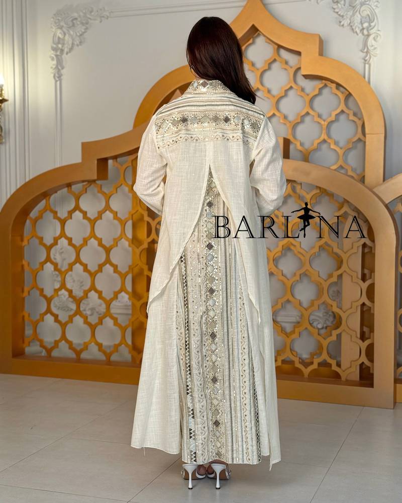 A cream-colored jalabiya with embroidery details and an oriental touch.