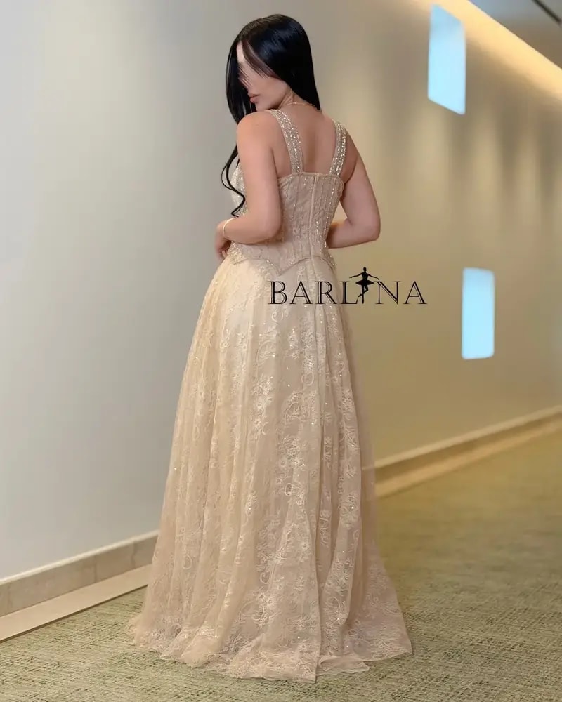 A luxurious flowing beige lace evening dress