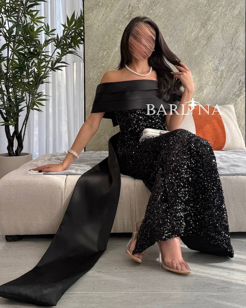 Black shiny dress with a long and distinctive design