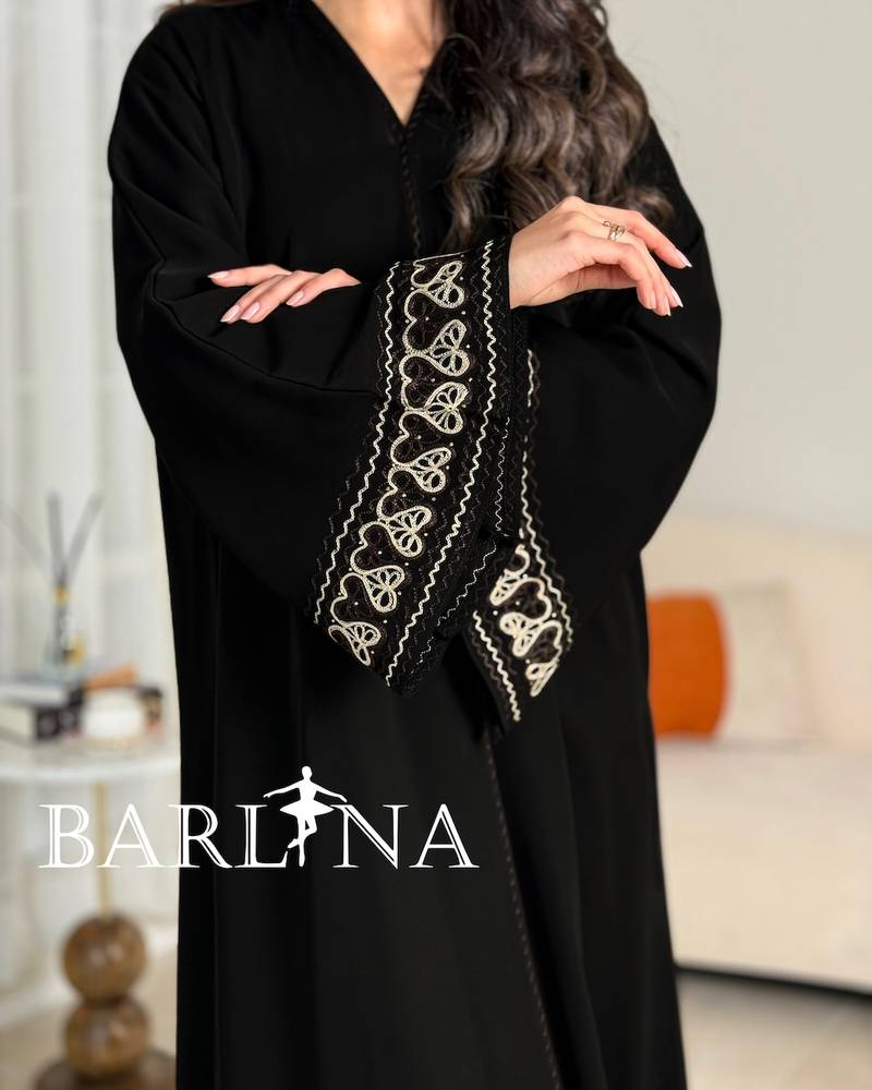 A soft black abaya with prominent beige embroidery