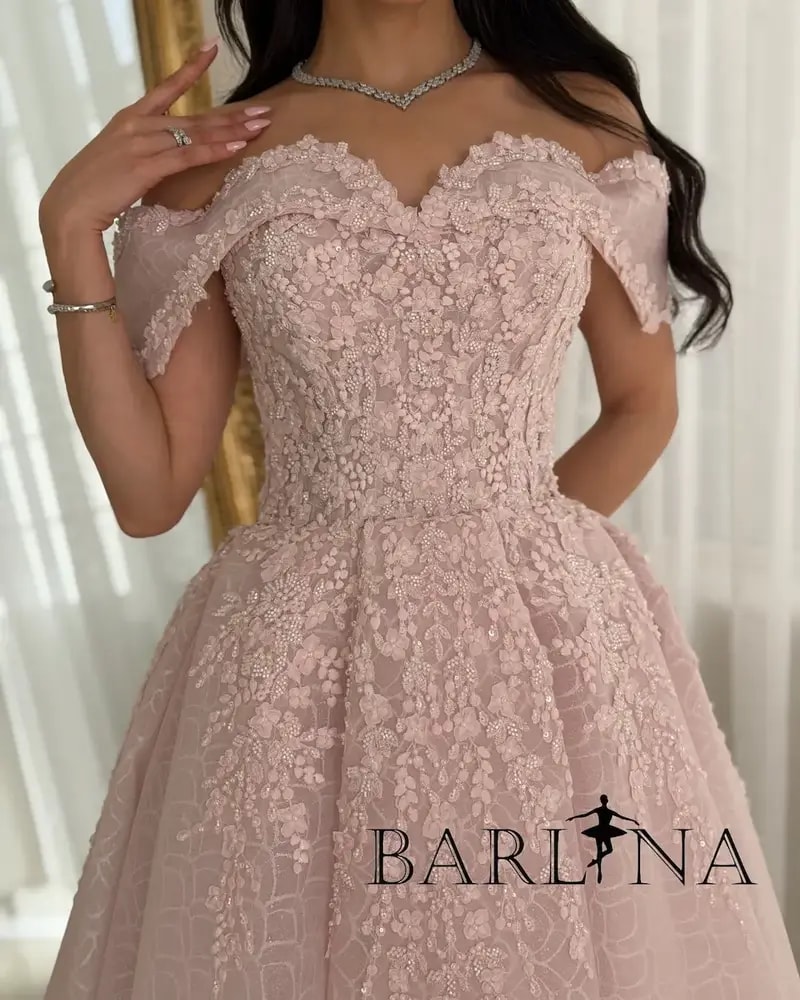 A pink puffy evening dress adorned with delicate embroidery
