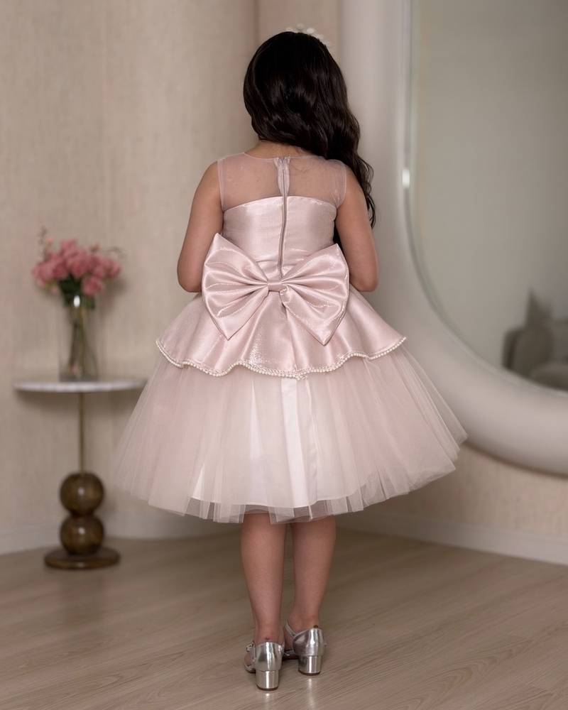 Pink girl's dress decorated with sparkly embroidery