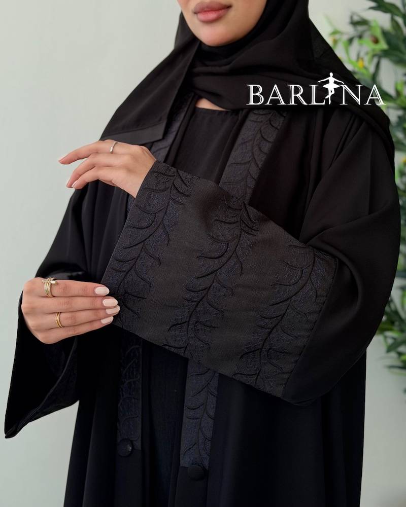 Black abaya with a flowing design and light embroidery
