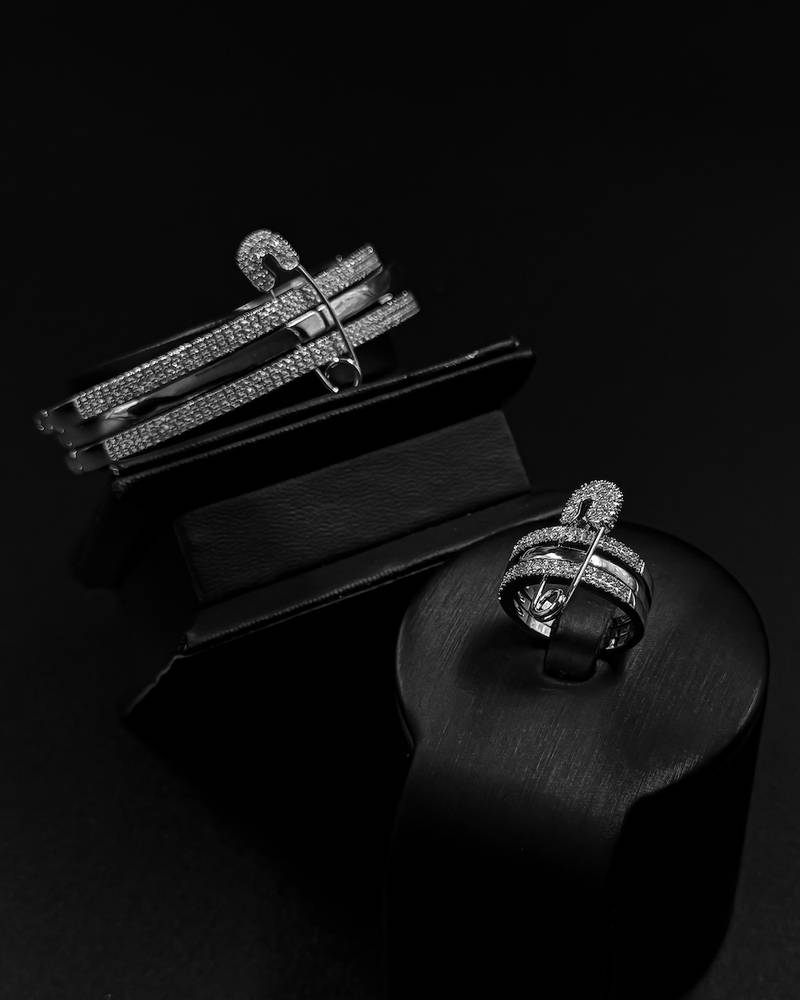 Bracelet and ring designed with crossed studded lines