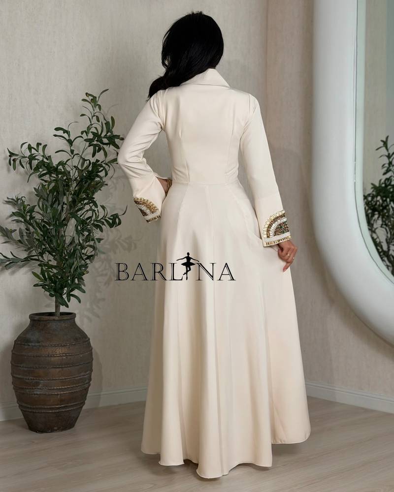 Beige dress with patterns on the neck and sleeves