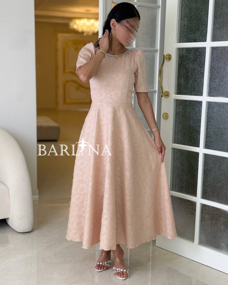 Light beige dress embroidered with delicate lace
