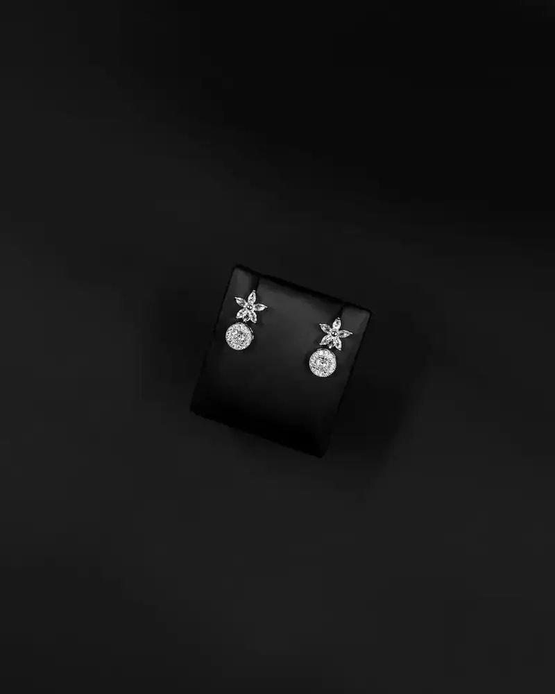 Floral stud earrings with a circular pendant