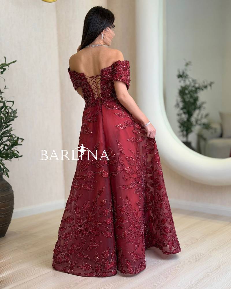 Burgundy dress with shimmering embroidery throughout the design