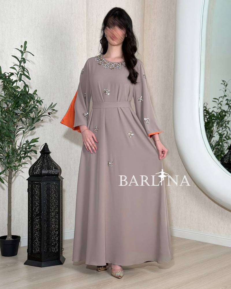 A soft gray jalabiya adorned with delicate embroidery