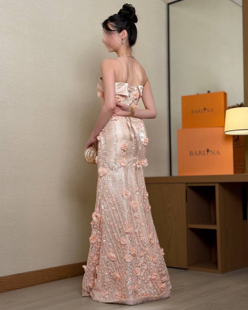 Elegant peach evening dress with an open neckline