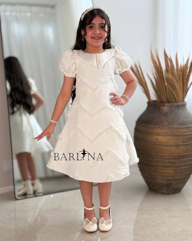 Off-white girls' dress with embroidered fabric