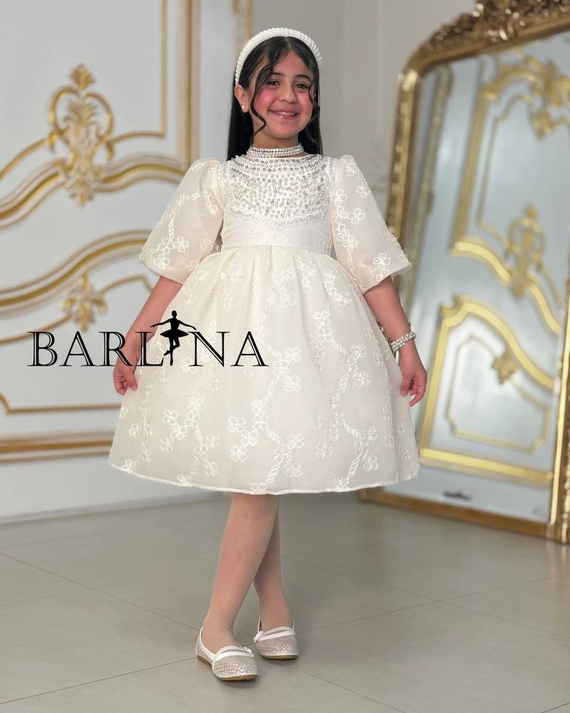 A soft, pearl-decorated girl's dress