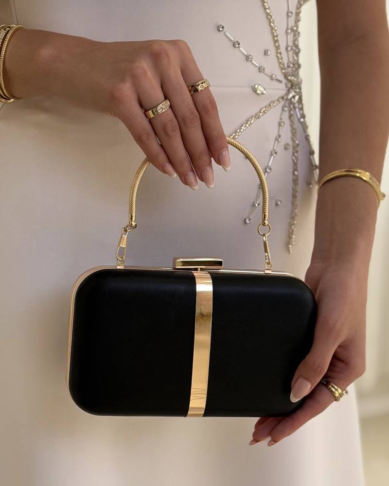 Evening bag decorated with a gold metal ribbon