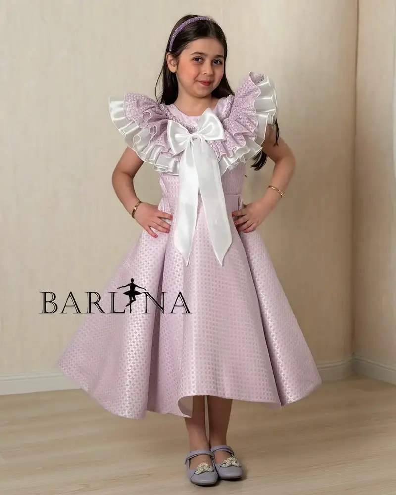Purple girl's dress decorated with a large bow
