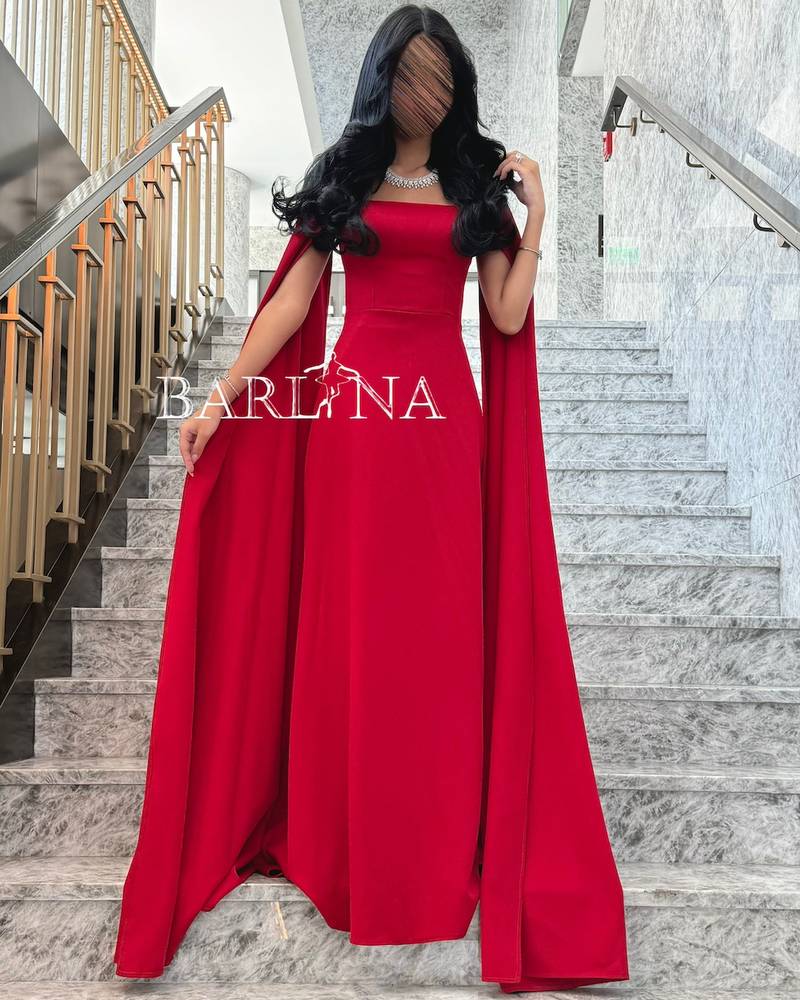 Soft red dress with long cape sleeves
