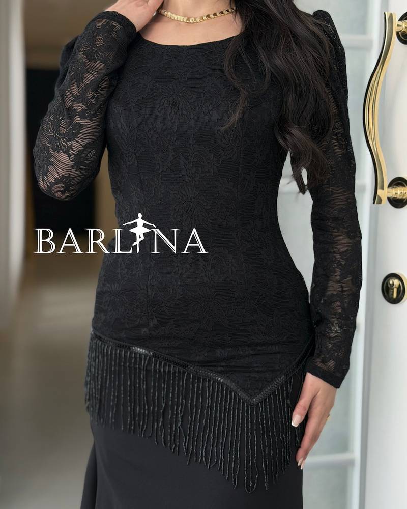 A soft black dress with lace and fringe details