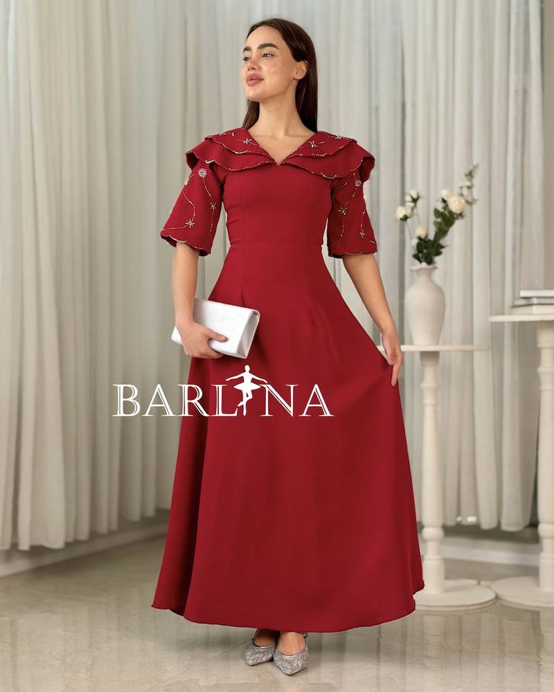 Long red dress with embroidered sleeves