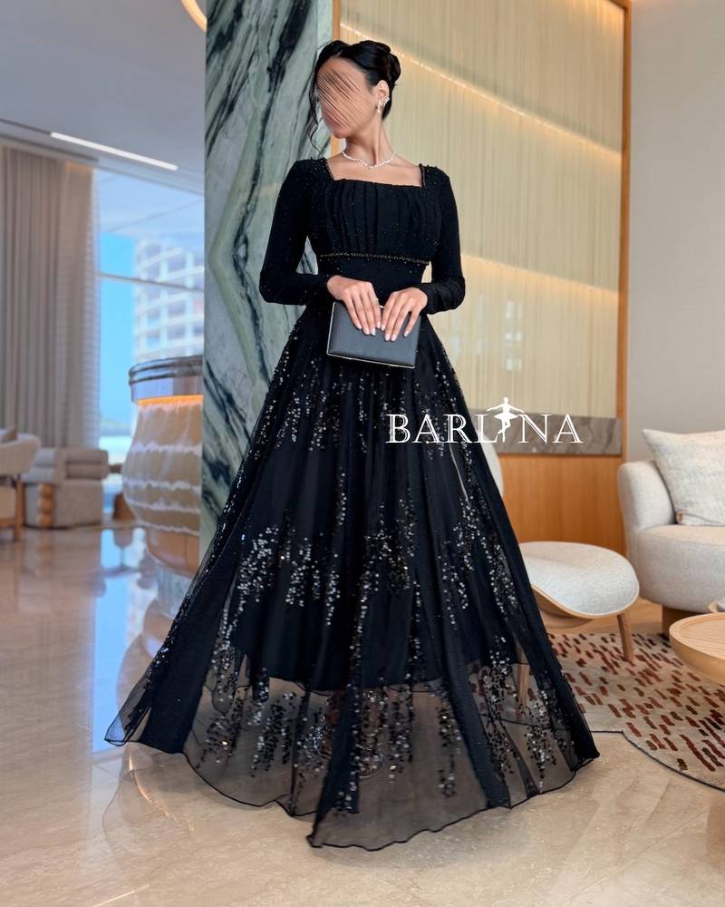 Black dress with a tulle layer decorated with sequins