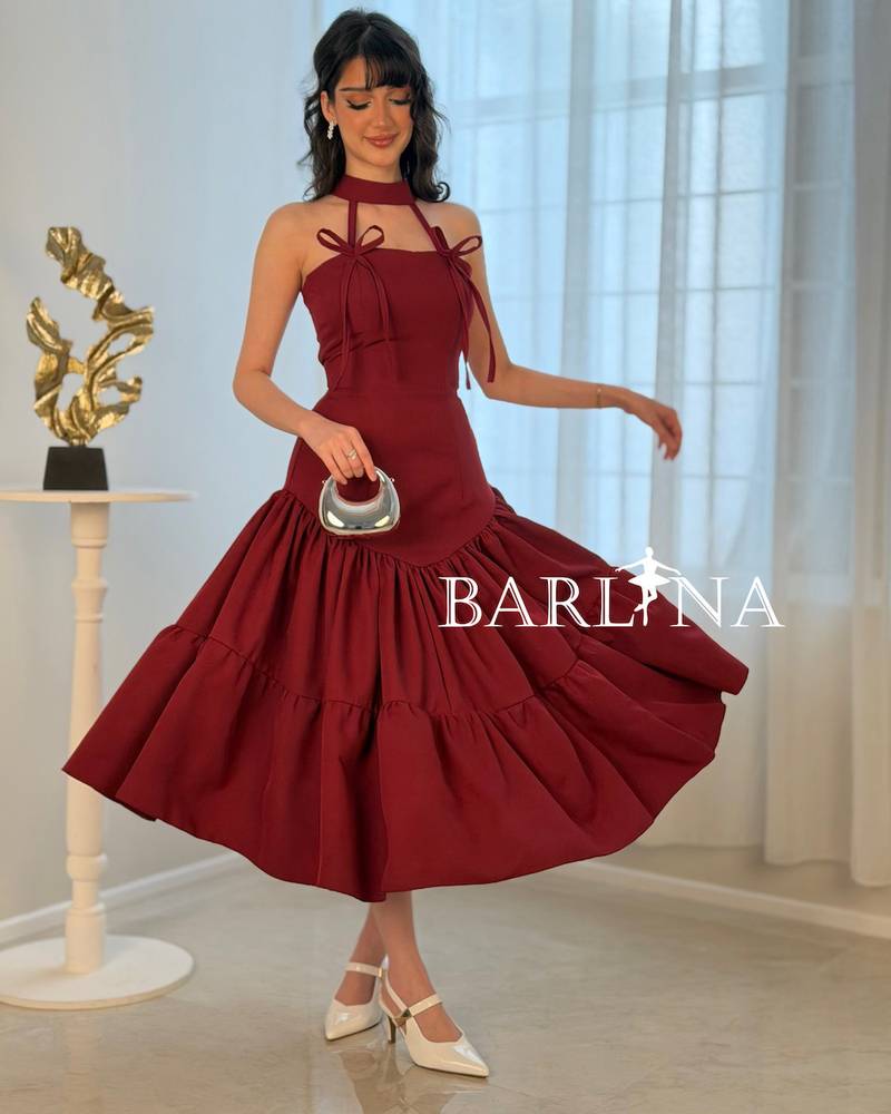 A soft burgundy dress adorned with elegant bows
