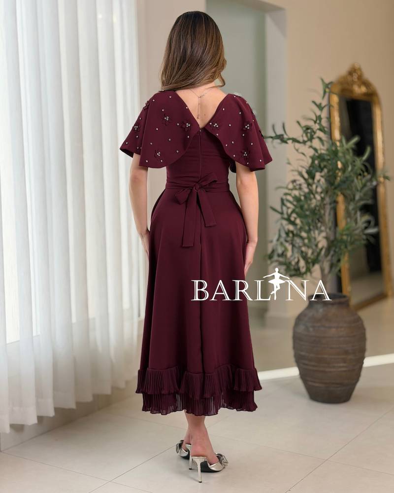 A soft, burgundy flared dress with delicate details