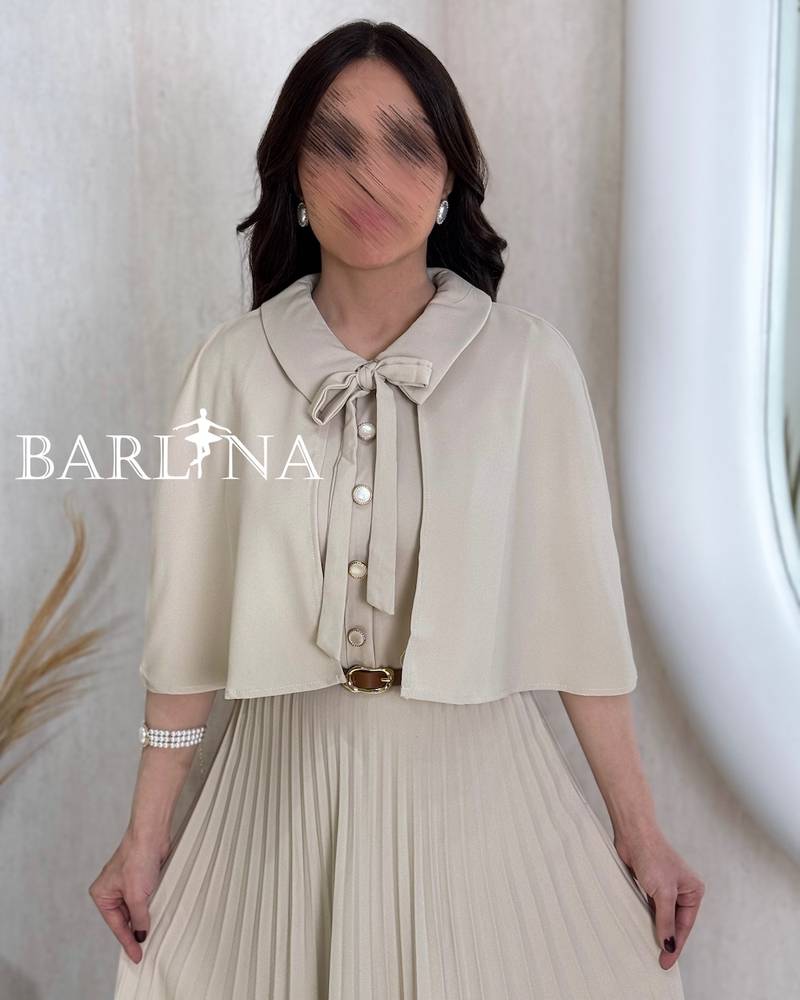 Beige pleated dress with a short flowing cape
